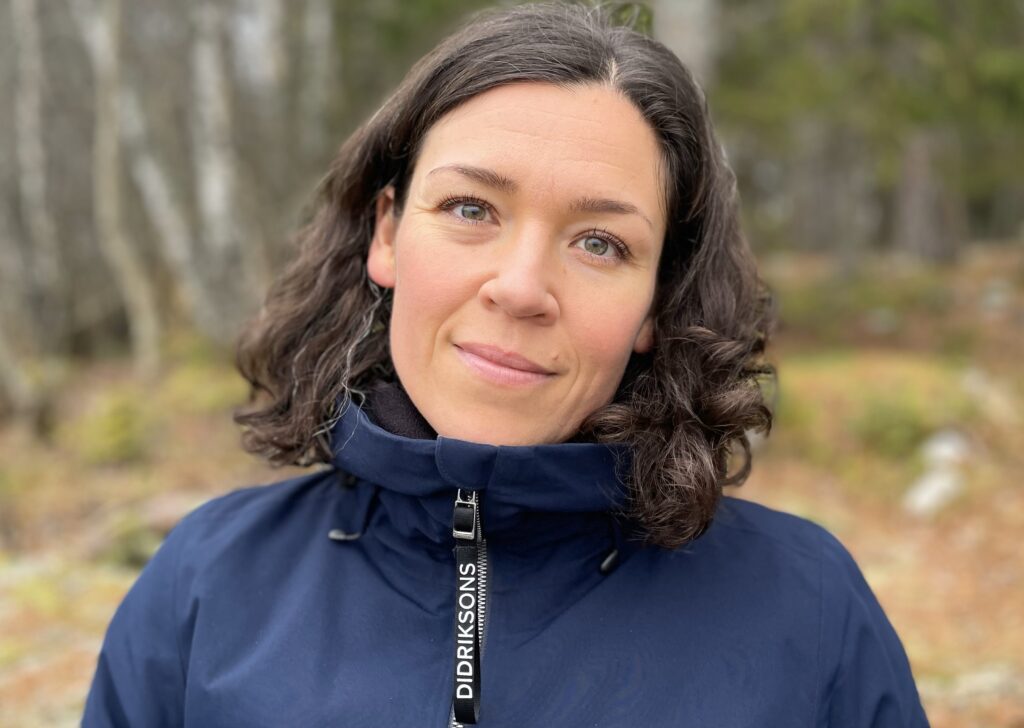 Porträttbild på Återhämtningsterapeut Anna Ekerli ute i naturen.